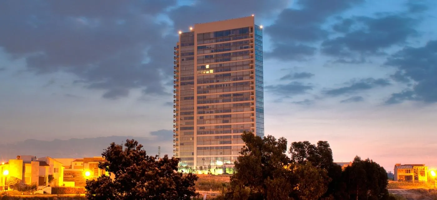 A tower rising above the trees at dusk